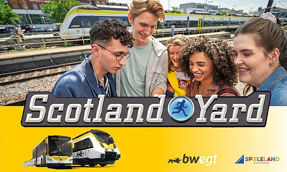 Junge Leute am Bahnhof, davor Bus und Zug im bwegt-Design und ein großer Scotland-Yard-Schriftzug
